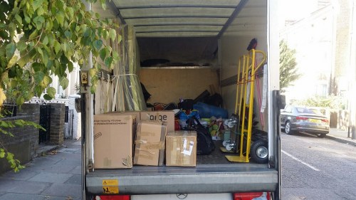 Builders skip being loaded with construction waste in Queens Park