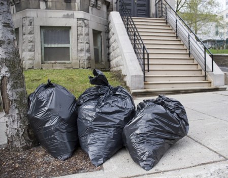 Business team efficiently using a skip for waste disposal